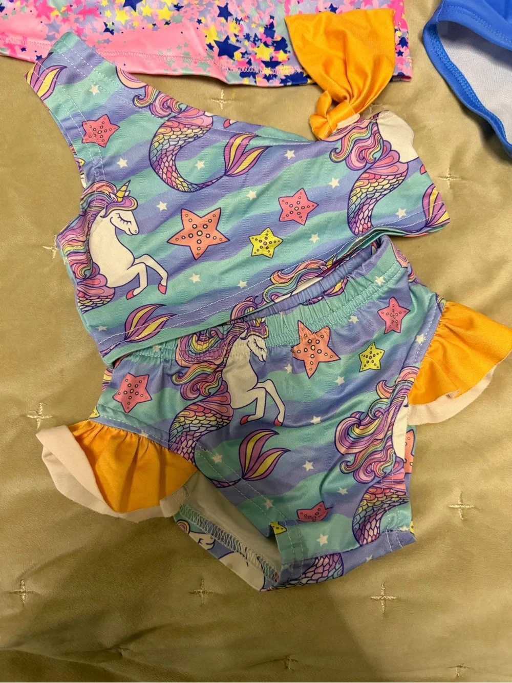 Champion Kids Swim Shirt with two bikinis featuring unicorns and flowers